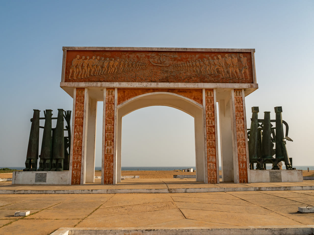 spiritual travelers bow to the Door of No Return - a solemn memorial to enslaved Africans